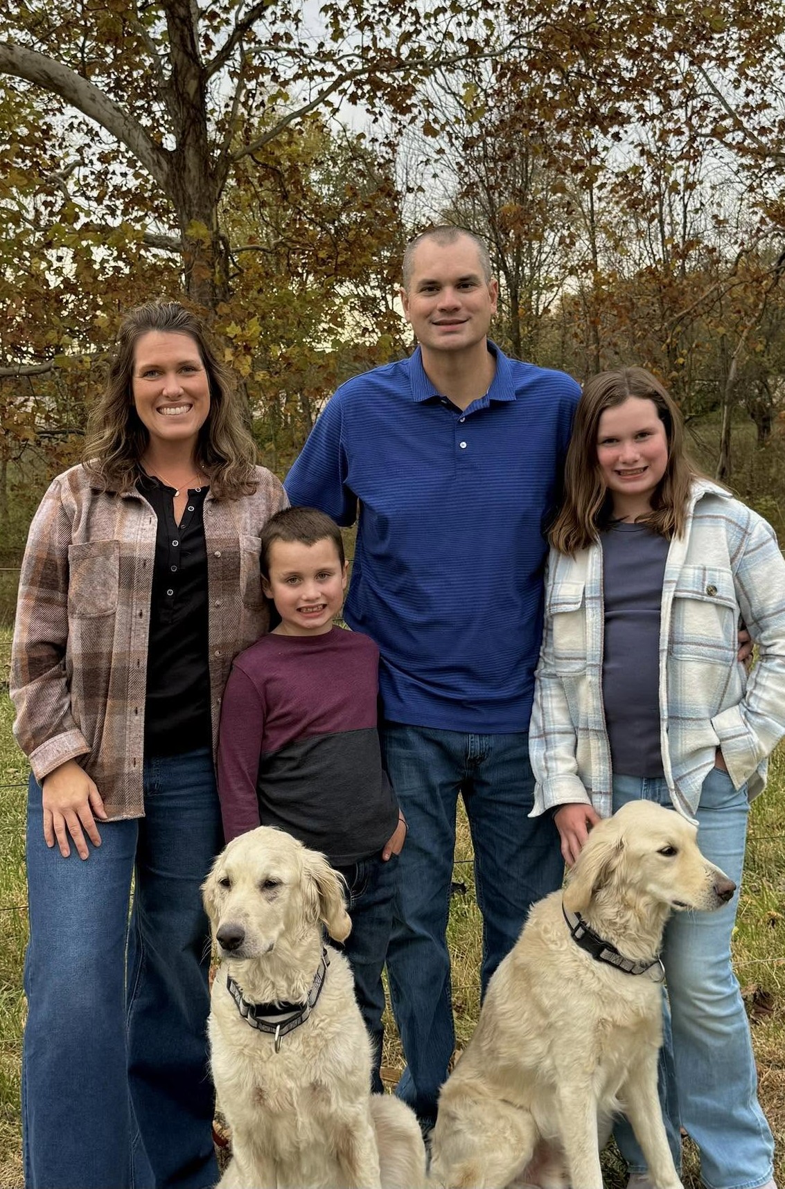 The Spry family with their golden retrievers