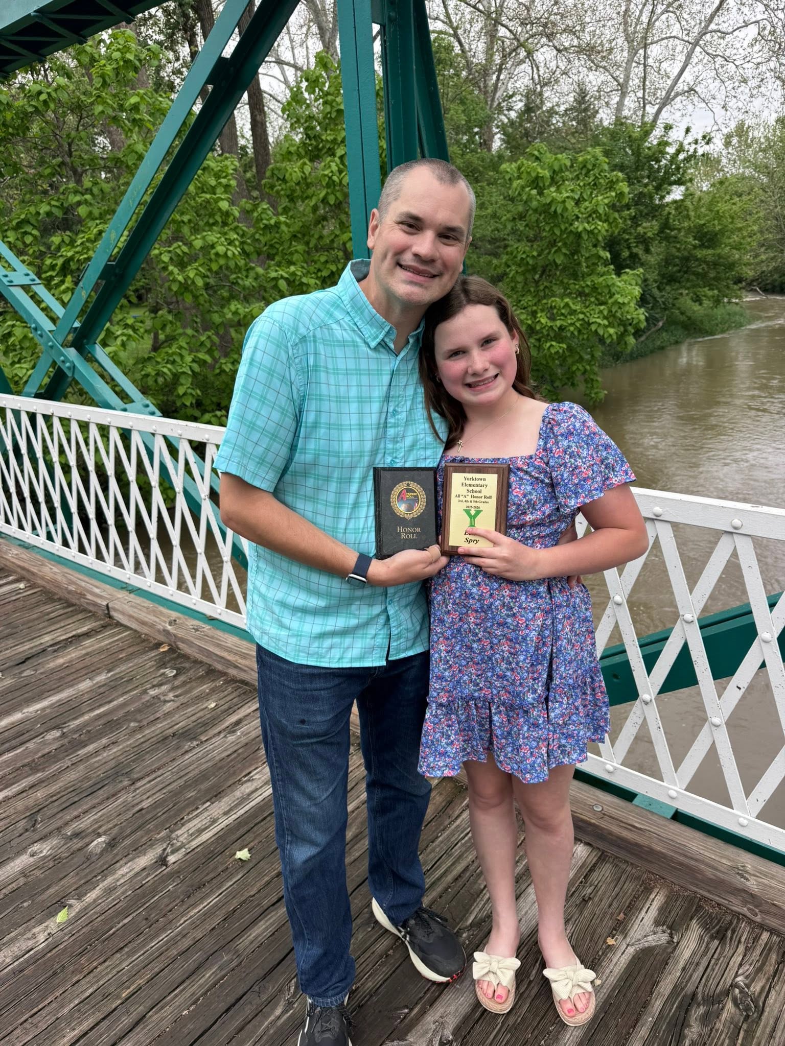 Thomas and his daughter with her Yorktown Elementary honor roll plaque